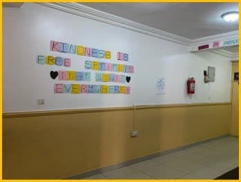 A school hallway lettered with the words kindness is free